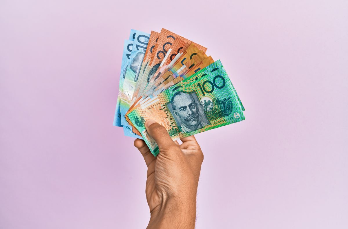 Australian currency being held on a hand